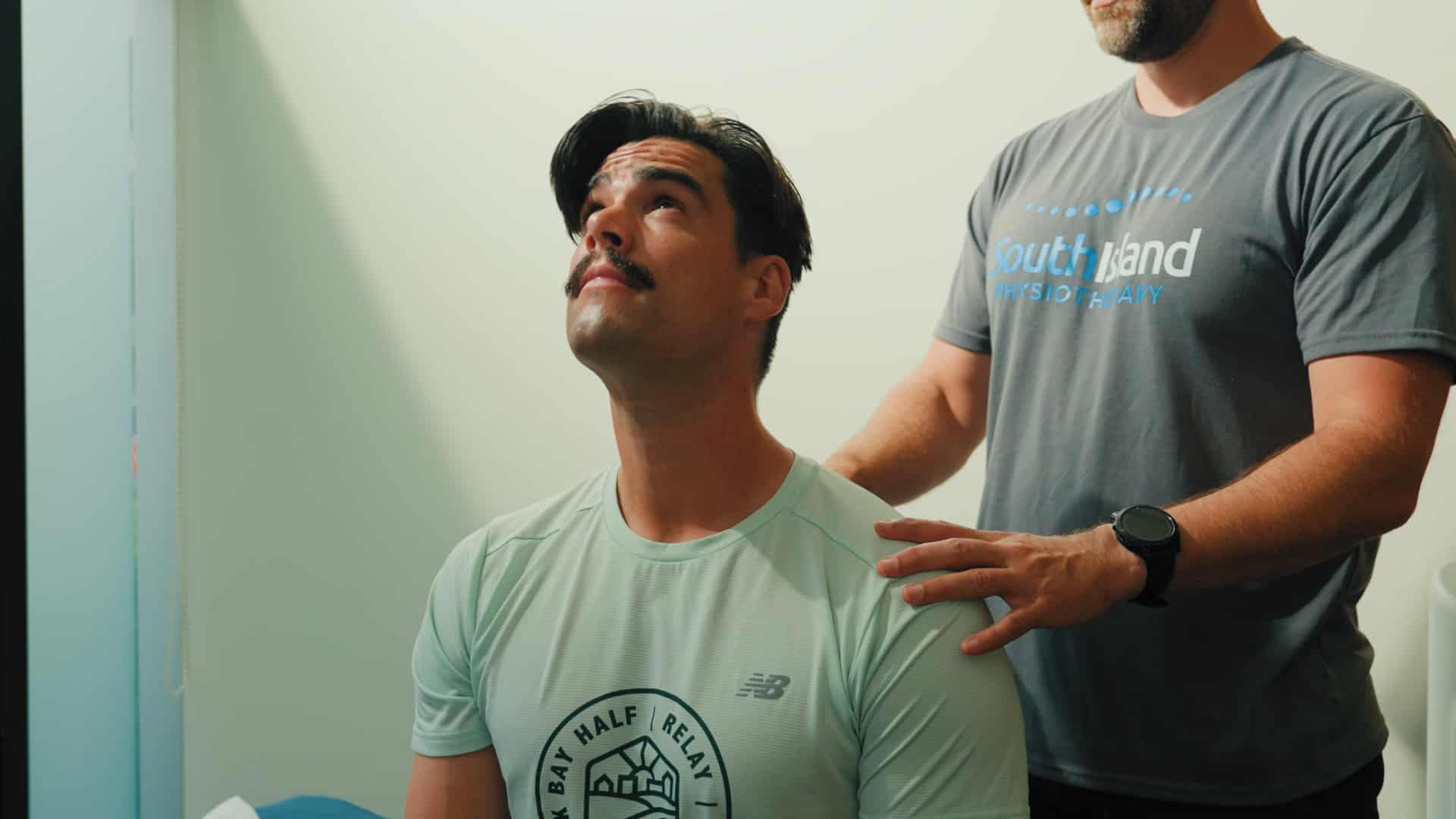 Physiotherapist providing shoulder assessment to a patient in clinic.
