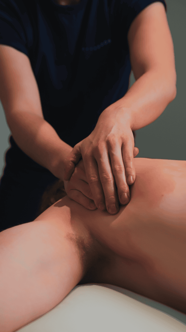 Physiotherapist performing manual therapy on a patient's back in a clinic setting.