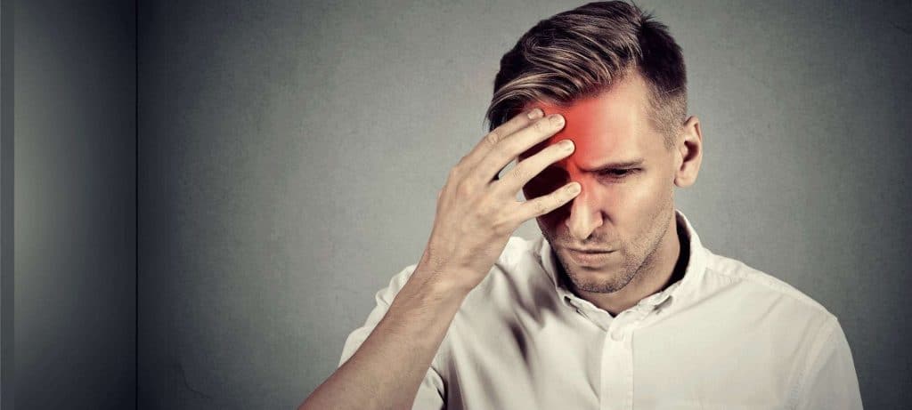 man-holding-head-with-a-headache