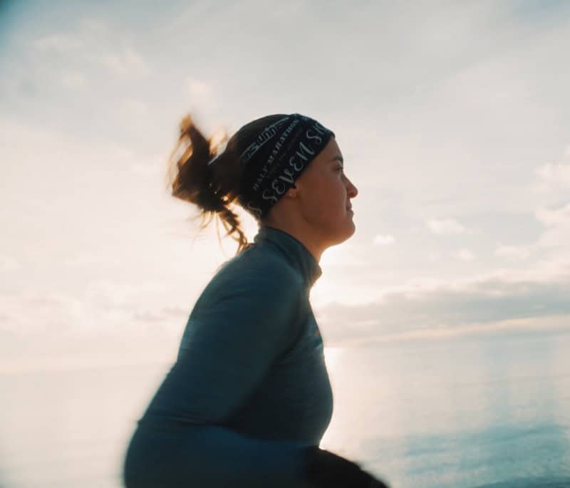 Woman exercising outdoors at sunset, emphasizing physiotherapy, health, and fitness.